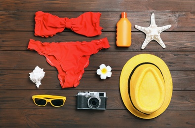 Photo of Flat lay composition with beach objects on wooden background