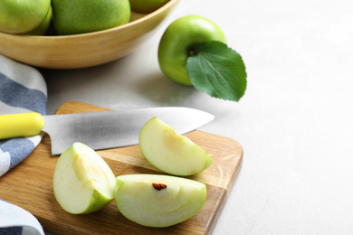 Composition with juicy green apples on white table, space for text