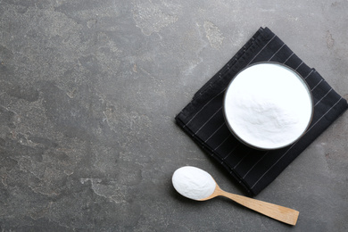 Photo of Baking soda on grey table, flat lay. Space for text