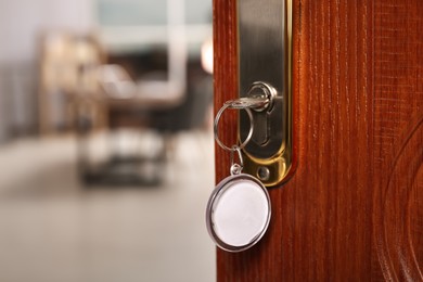 Photo of Closeup view of door with key open into room. Space for text