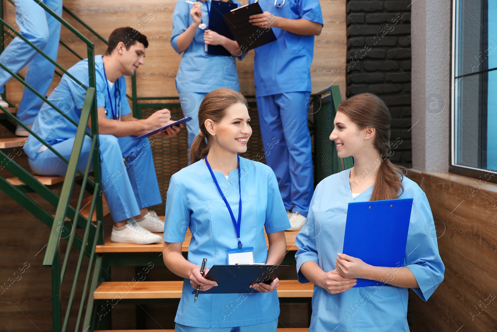 Photo of Young smiling medical students in university hall