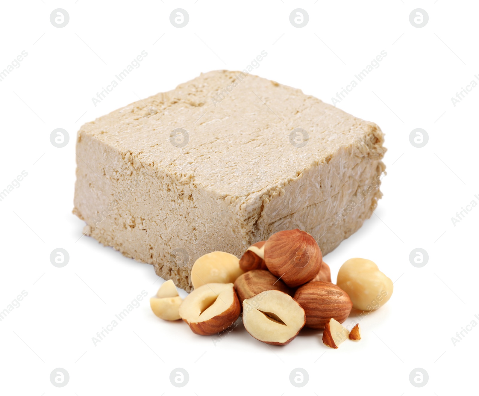 Image of Tasty halva and hazelnuts isolated on white