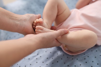 Photo of Mother with her cute little baby in crib, closeup