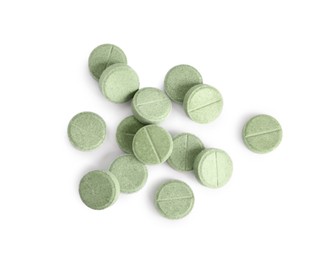 Many light green pills isolated on white, top view