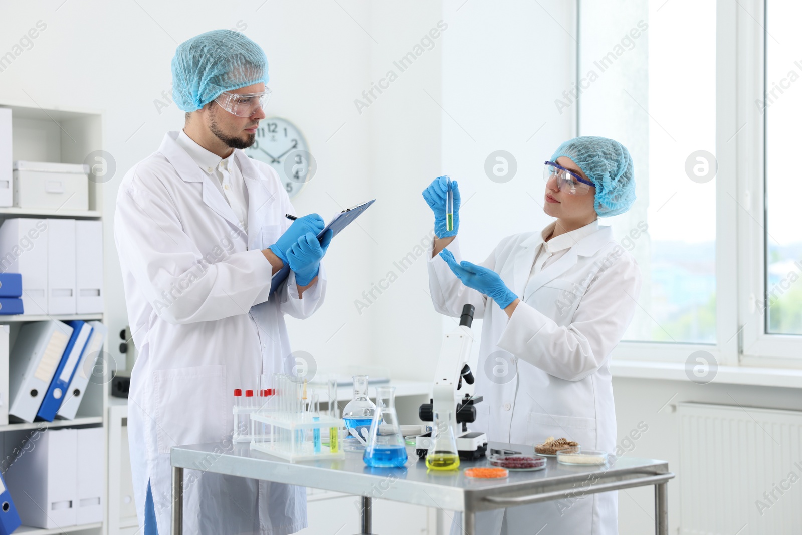 Photo of Quality control. Food inspectors checking safety of products in laboratory