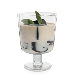 Photo of Glass of milk with grass jelly and green leaves isolated on white