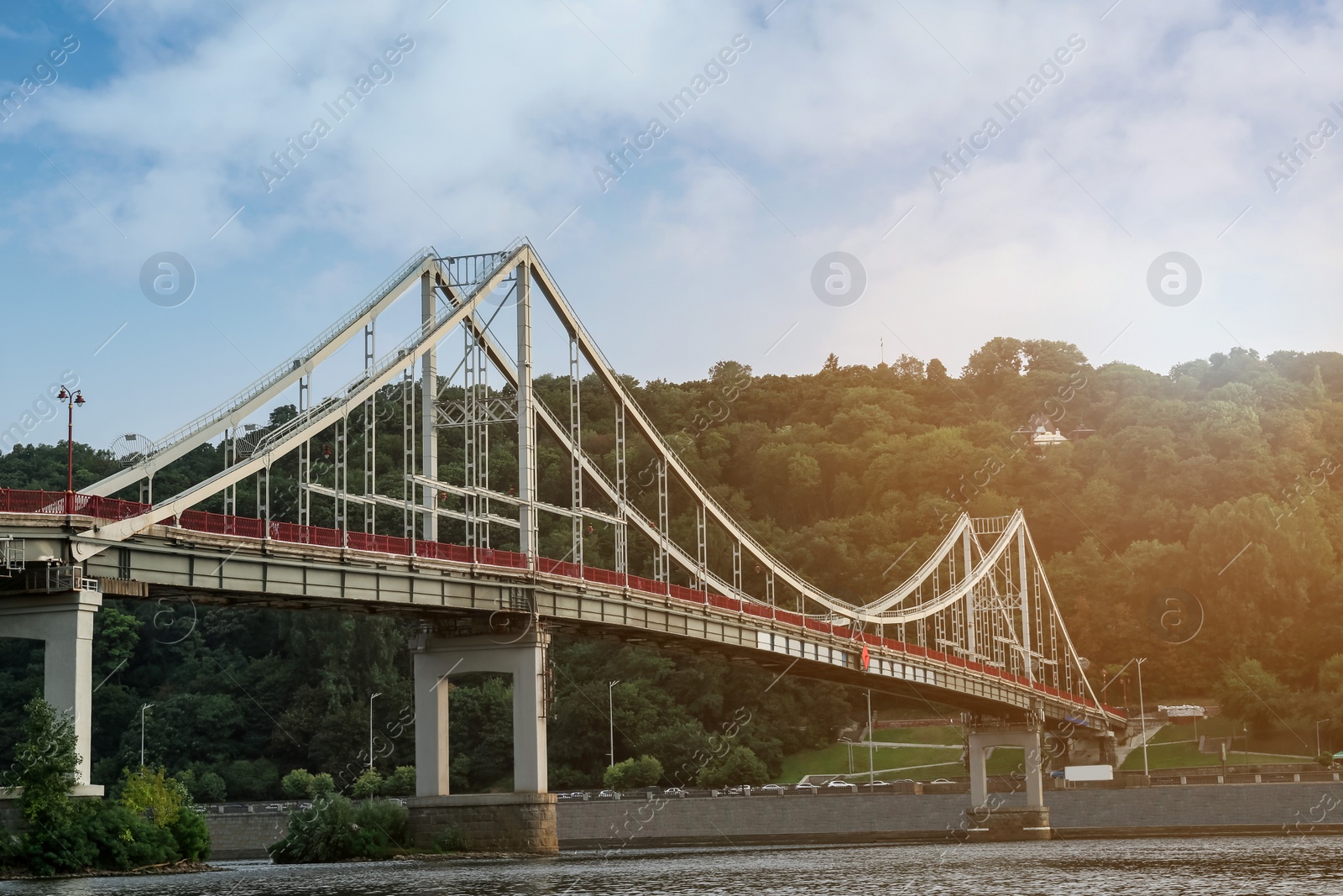 Photo of KYIV, UKRAINE - AUGUST 11, 2022: Beautiful cityscape with pedestrian Park bridge over Dnipro river