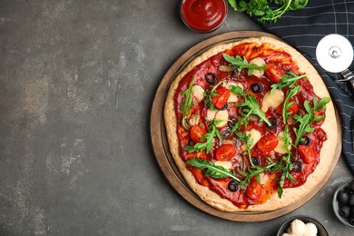 Photo of Pita pizza with cheese, olives, tomatoes and arugula on grey table, flat lay. Space for text