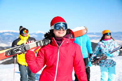 Photo of Young woman with ski at resort. Winter vacation