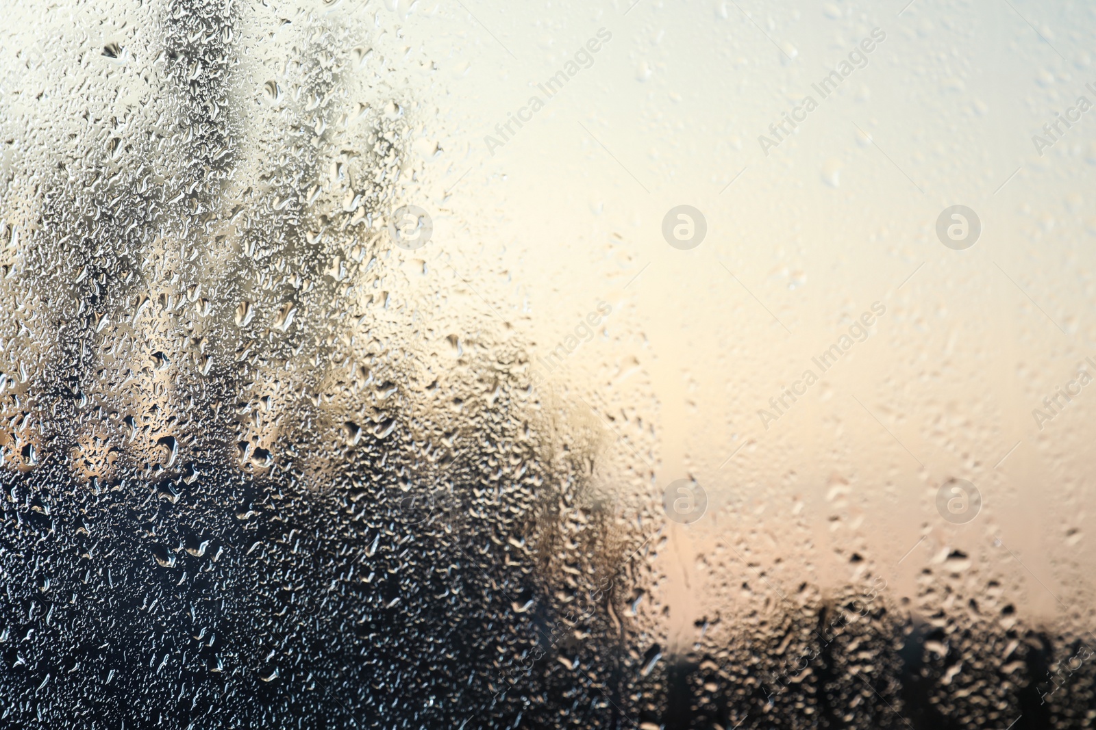 Photo of Rain drops on window glass as background, closeup