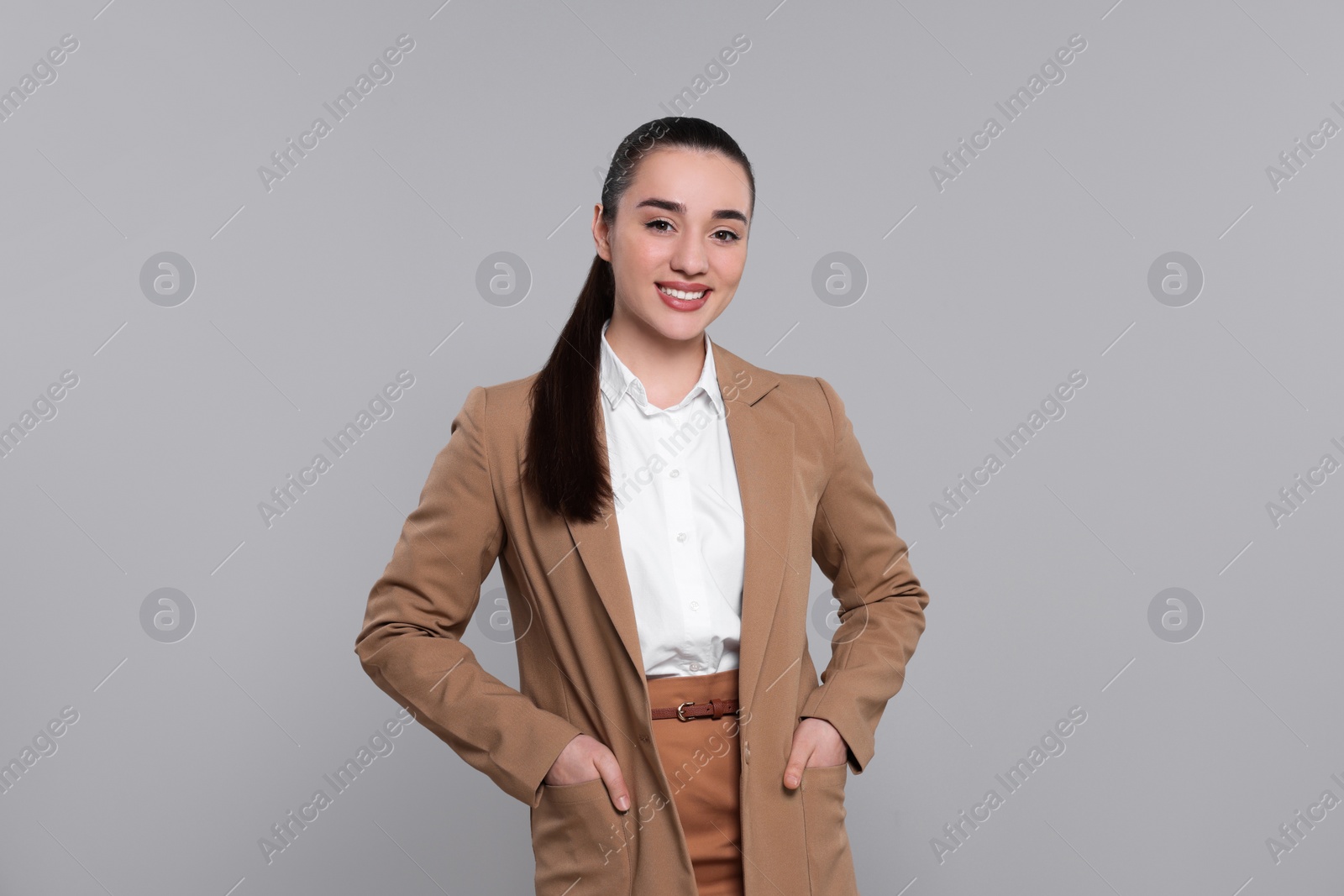 Photo of Happy real estate agent on grey background