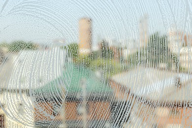 Photo of Glass covered with suds as background, view from inside