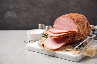 Photo of Delicious cooked ham served on grey table
