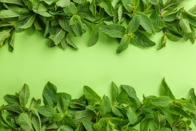 Fresh green mint leaves on color background, top view