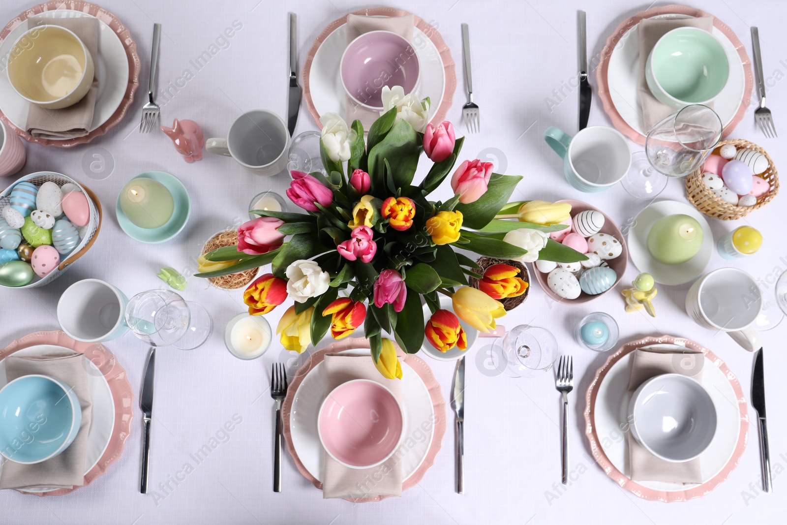 Photo of Festive table setting with beautiful flowers, flat lay. Easter celebration