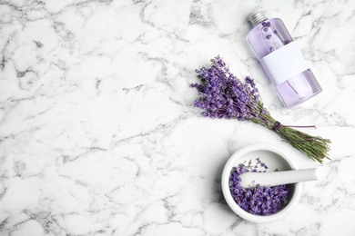 Flat lay composition with lavender flowers and natural cosmetic on marble background