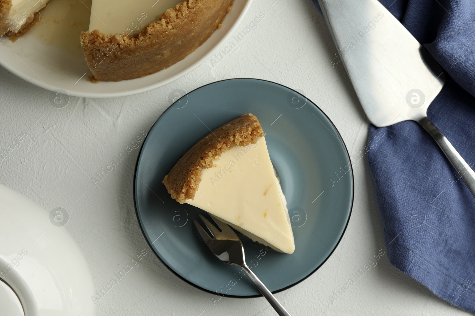 Photo of Piece of tasty vegan tofu cheesecake served on white table, flat lay