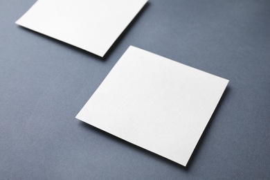 Photo of Blank note papers on dark grey background. Mock up for design