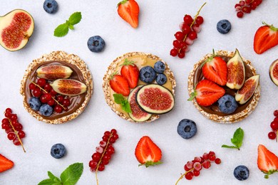 Photo of Flat lay composition with tasty crispbreads and berries on light table