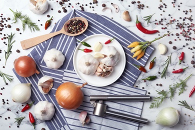 Photo of Flat lay composition with garlic, peppers and onions on marble table