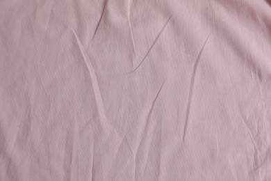 Photo of Crumpled pink fabric as background, top view