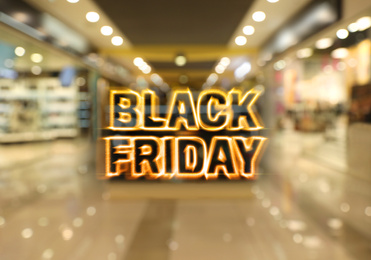 Blurred view of modern shopping mall interior. Black Friday Sale