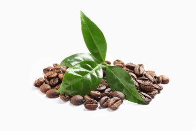 Photo of Fresh green leaves and pile of coffee beans isolated on white