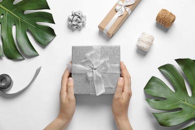 Photo of Woman with beautiful gift boxes on white background, top view