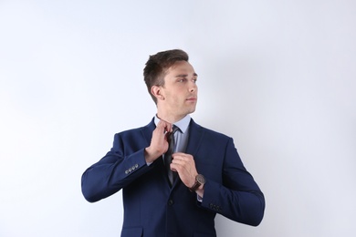 Photo of Handsome young man in suit on white background