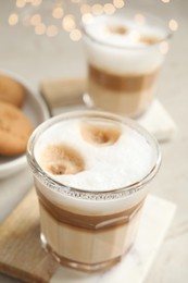 Photo of Glasses with delicious latte macchiato on white table