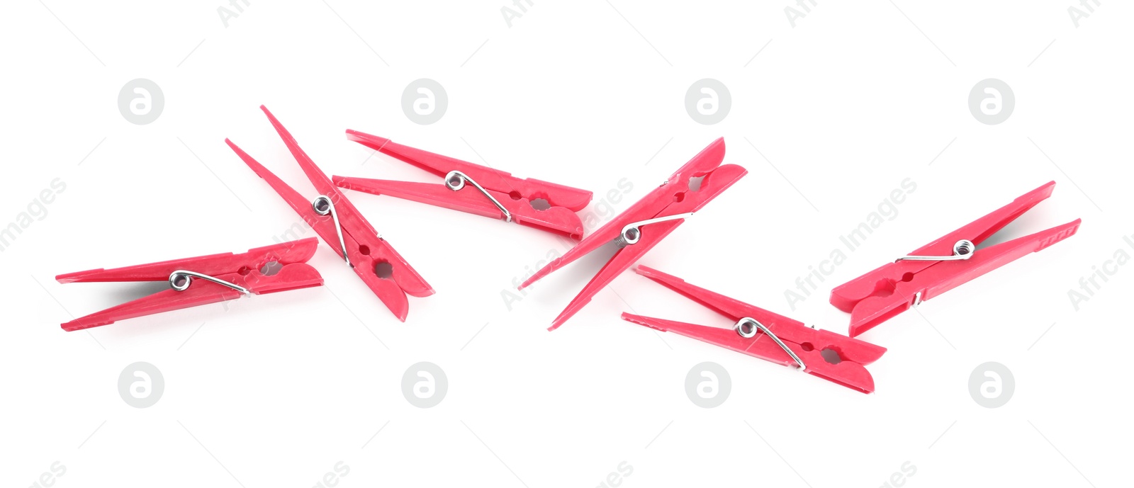 Photo of Bright pink plastic clothespins on white background, top view