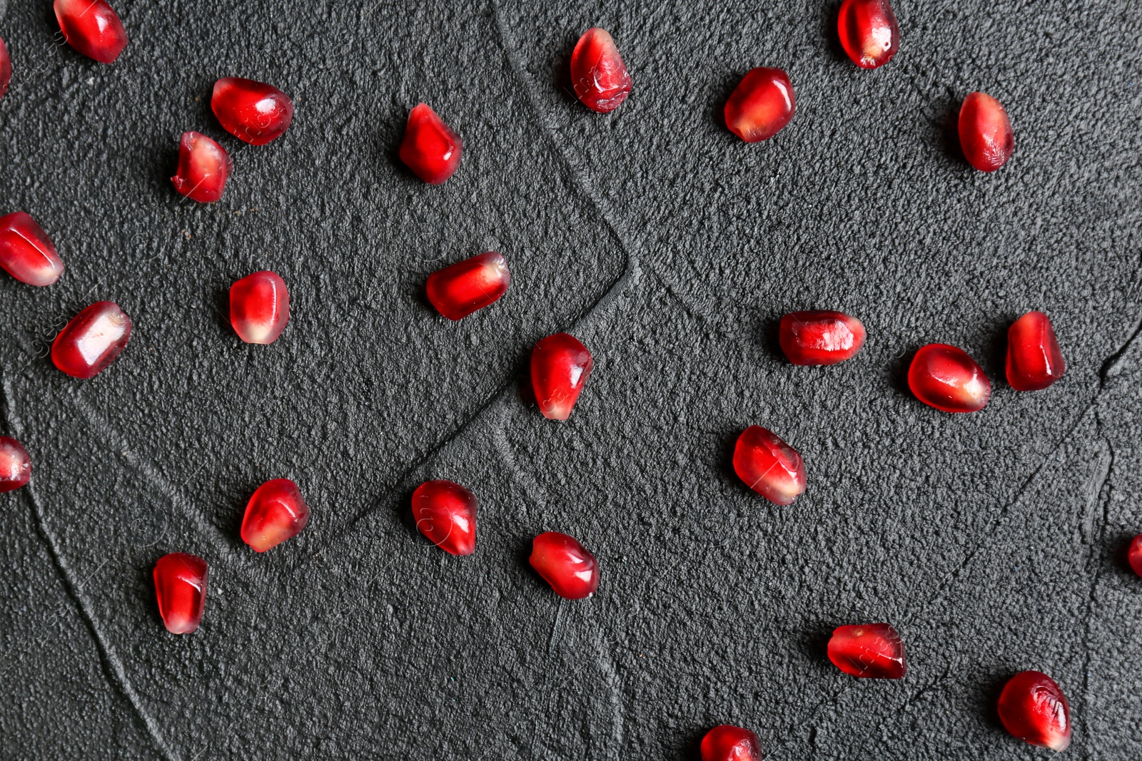 Photo of Fresh yummy pomegranate seeds on dark background