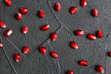 Fresh yummy pomegranate seeds on dark background