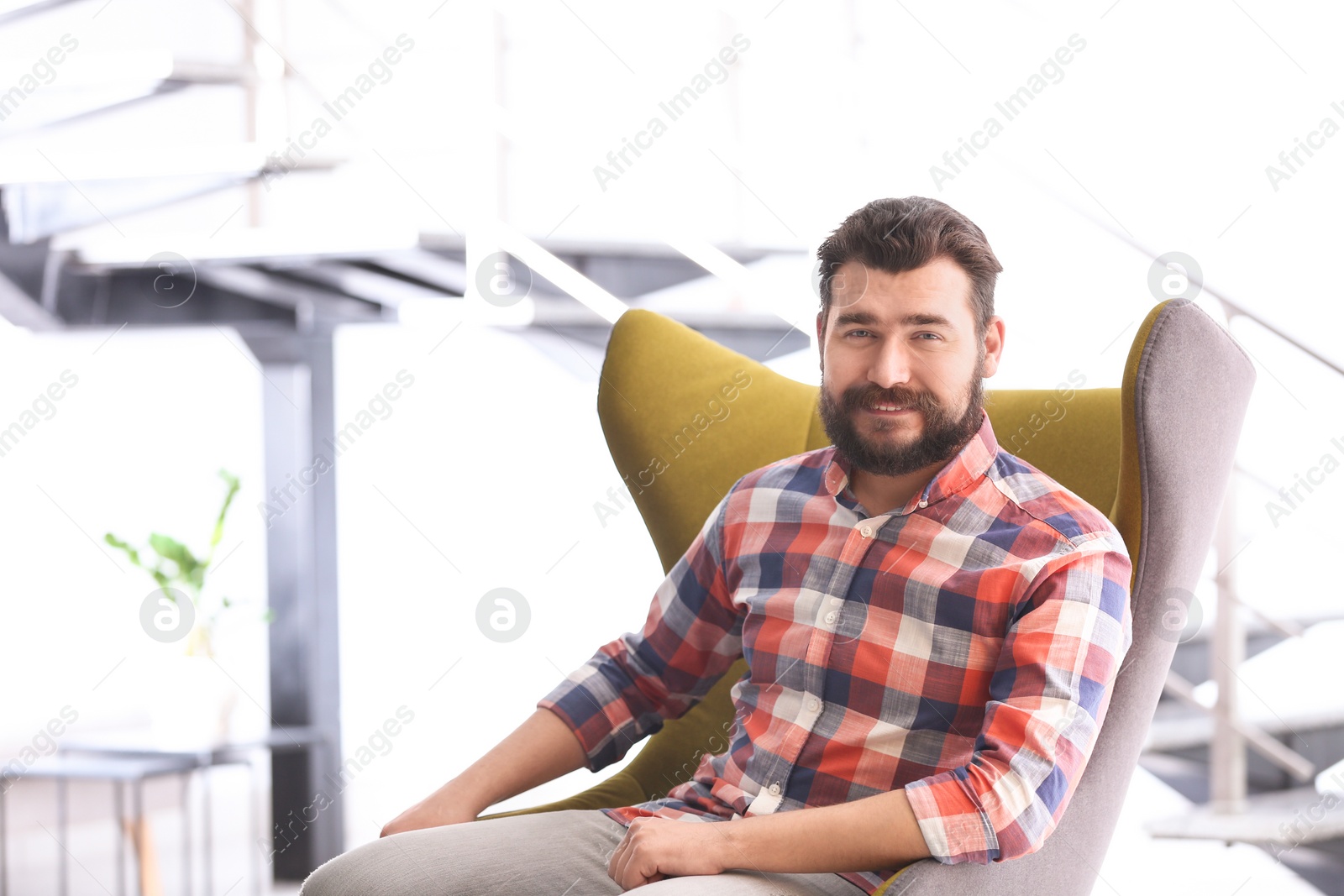 Photo of Portrait of confident mature man in armchair