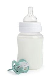 One feeding bottle with infant formula and pacifier on white background