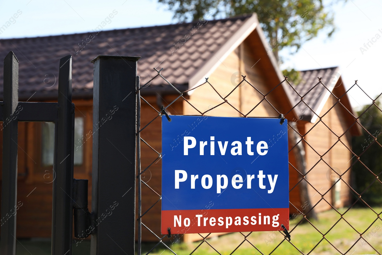 Image of Sign with text Private Property No Trespassing on fence