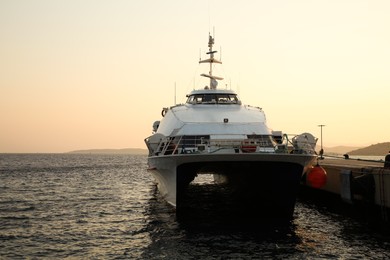 Photo of Picturesque view of modern ferry moored in sea port