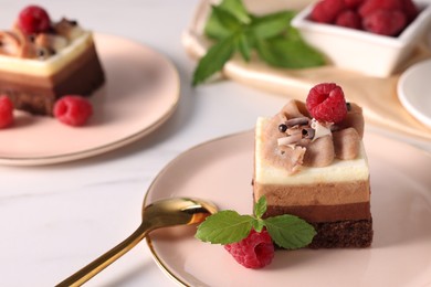 Piece of triple chocolate mousse cake with raspberries served on white marble table, closeup. Space for text