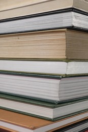 Stack of many different hardcover books as background, closeup