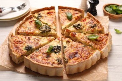 Photo of Delicious homemade vegetable quiche on white wooden table