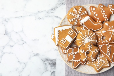 Plate with tasty homemade Christmas cookies on table, top view