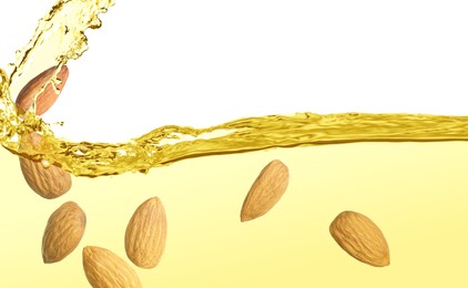 Image of Organic almond oil and tasty nuts on white background
