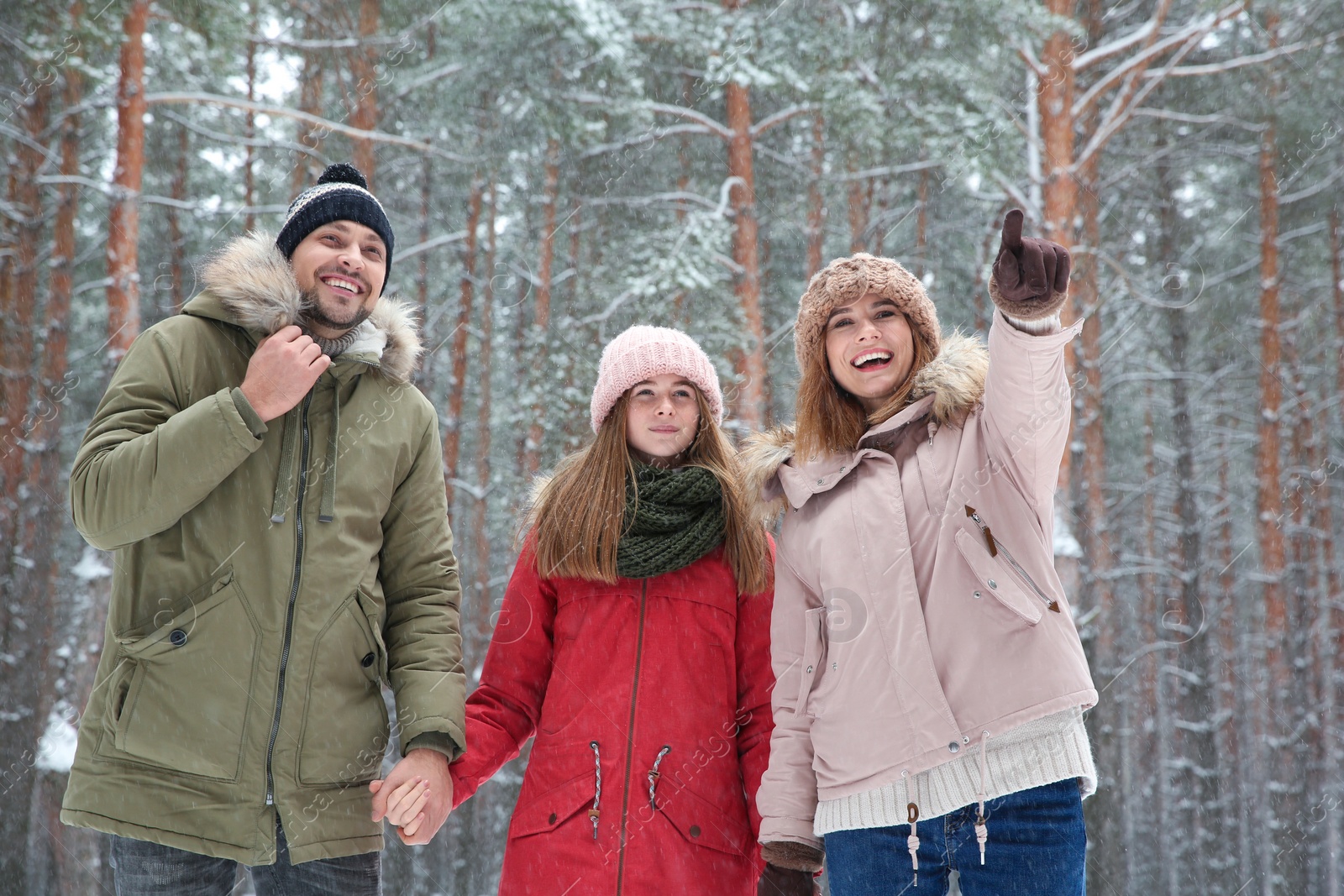 Photo of Happy family in forest on snow day