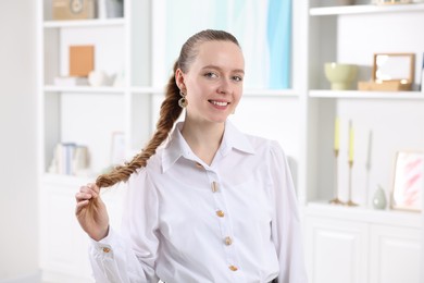 Woman with long braided hair at home