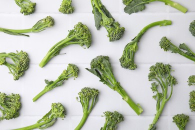 Fresh raw broccolini on white table, flat lay. Healthy food
