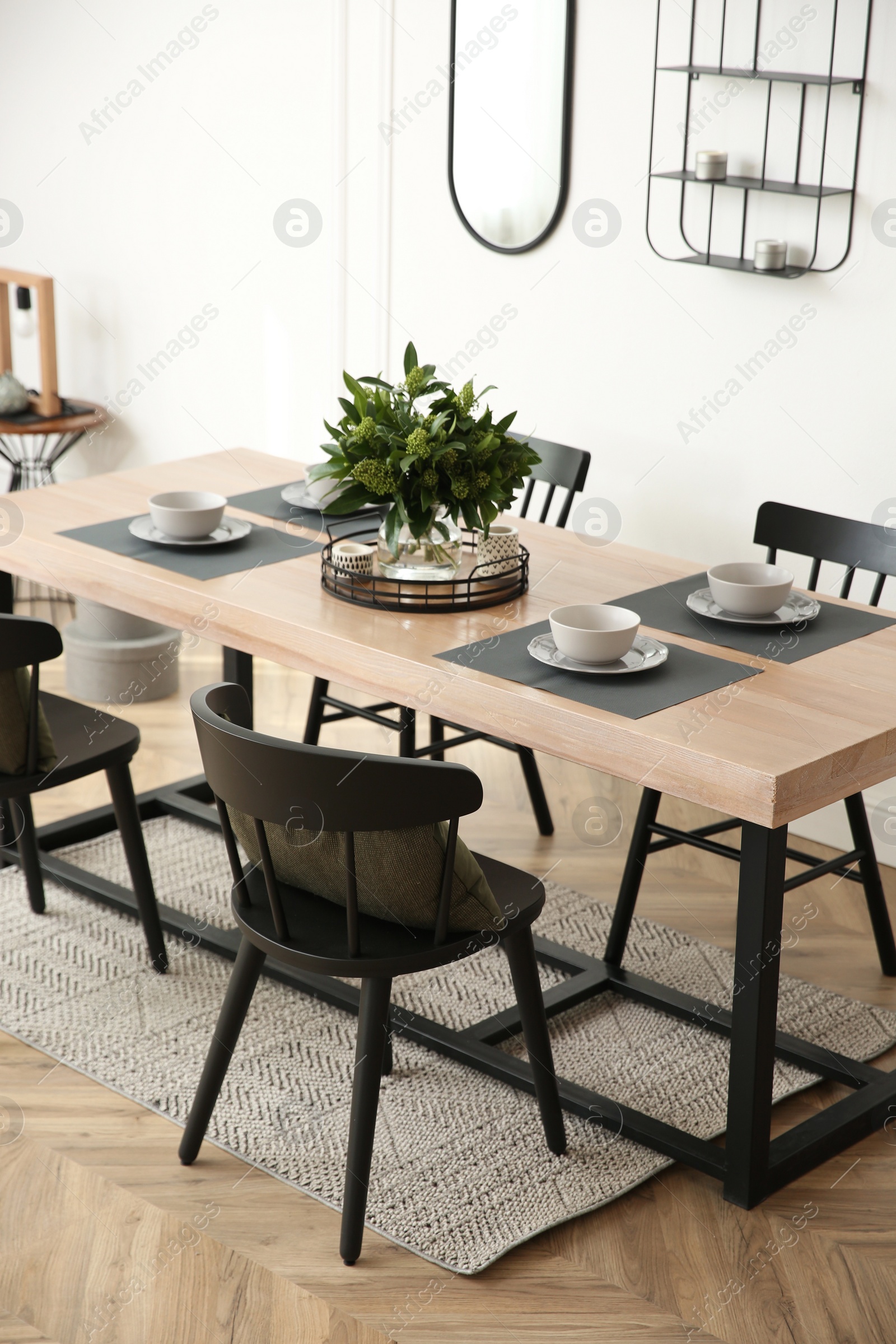 Photo of Stylish wooden dining table and chairs in room. Interior design