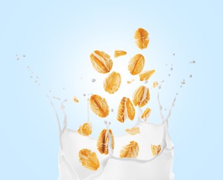 Rolled oats falling into splashing milk on light blue background