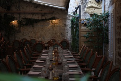 Beautiful cafe with table, chairs and green plants