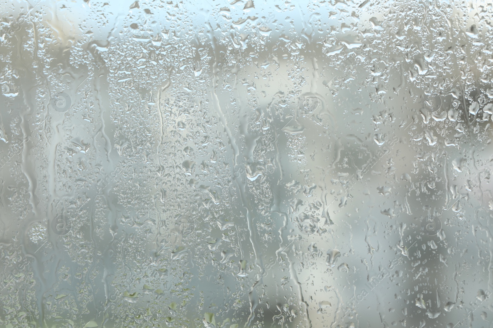 Photo of Window glass with raindrops as background, closeup