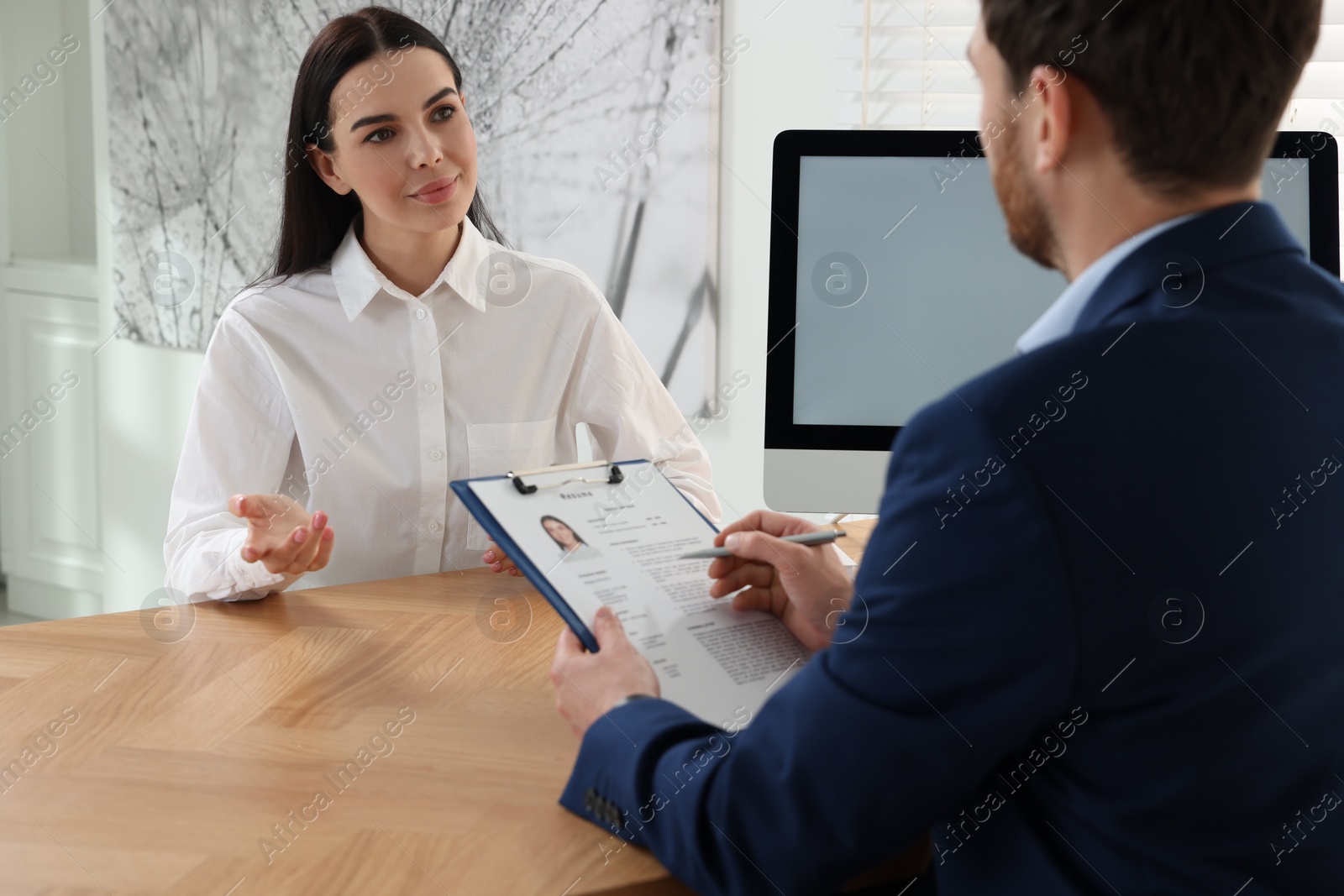 Photo of Human resources manager conducting job interview with applicant in office